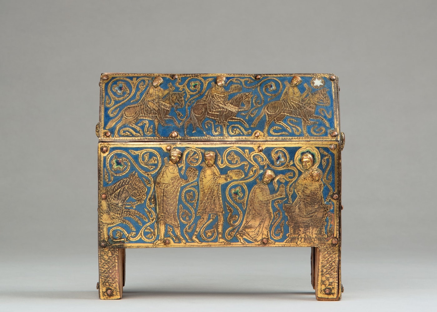 A reliquary chasse showing the Journey and Adoration of the Magi, c. 1230
France, Limoges
Cast, chased, engraved and gilded copper with champlev&amp;eacute; enamel, attached to a modern wooden core covered with pale red velvet lacking its pile
6 1/4 x 7 1/8 x 2 3/4 inches
(15.9 x 17.8 x 7 cm)
