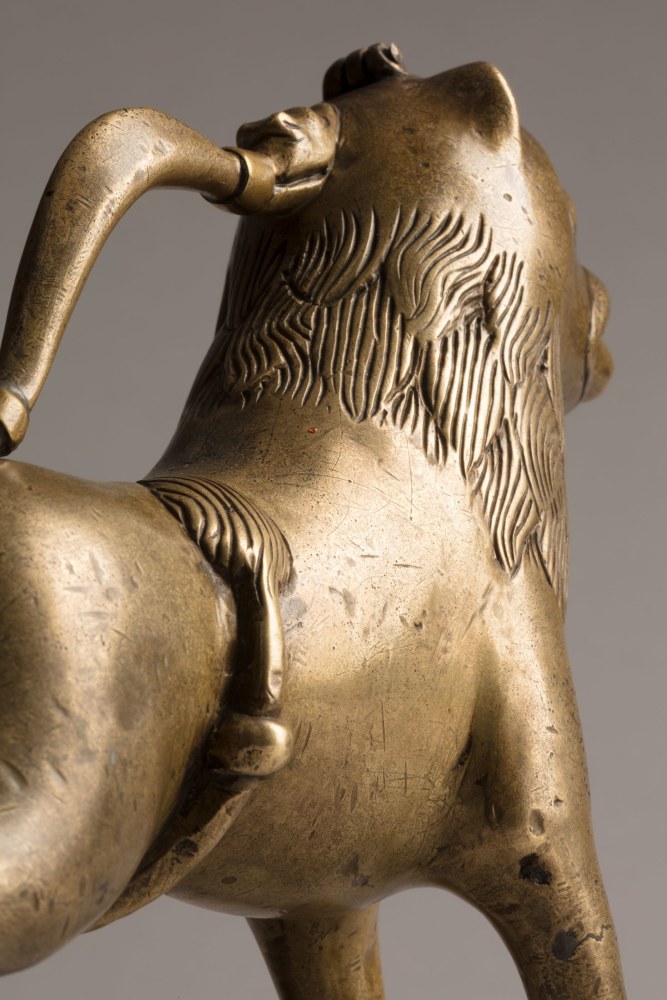 An aquamanile in the form of a lion, Early 13th century
Germany, probably Lower Saxony
cast copper alloy with fine soldered repairs to the handle at its upper and lower connecting points. Hairline fractures to the legs in two places. The hinged lid a modern replacement.
6 3/4 x 9 1/8 x 2 1/8 inches
(17.1 x 22.9 x 5.5 cm)